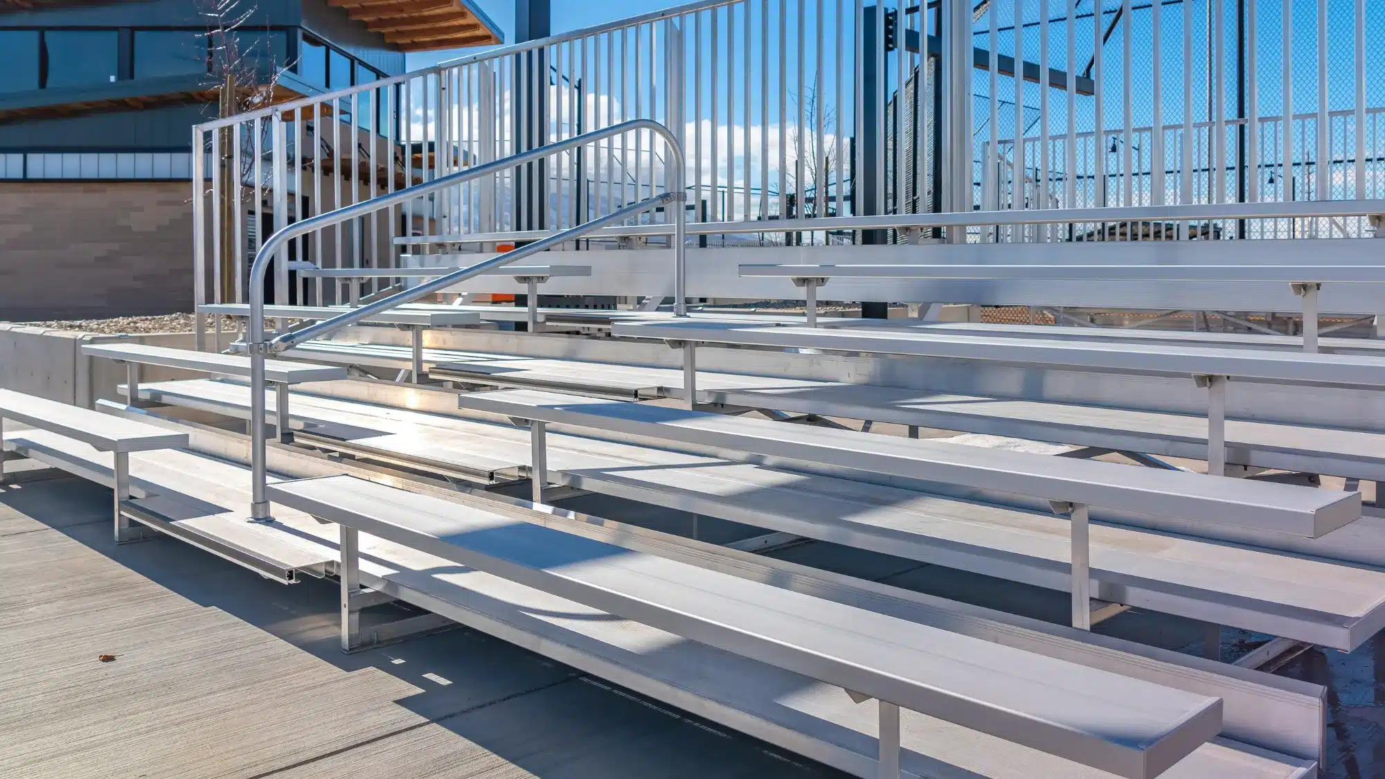 Annual bleacher inspection in Connecticut gymnasium showing structural safety checks of seating, railings, stairs, and support systems for compliance