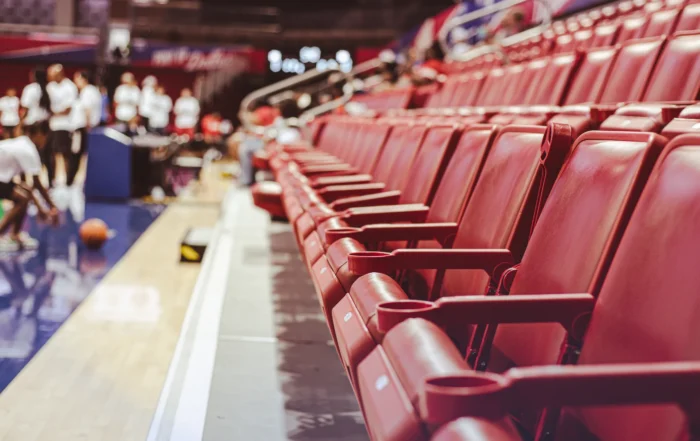 Skilled technicians performing urgent bleacher repairs in a stadium, prioritizing spectator safety.