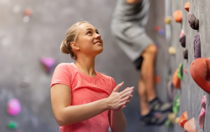 A group of people climbing an indoor wall together