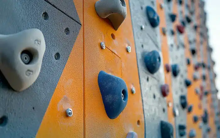 Close-up of durable climbing holds mounted on a professional climbing wall, highlighting quality construction and installation by experienced climbing wall installers.
